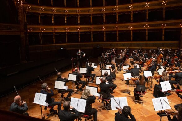 l'orchestra suona all'unisono seguendo il direttore d'orchestra